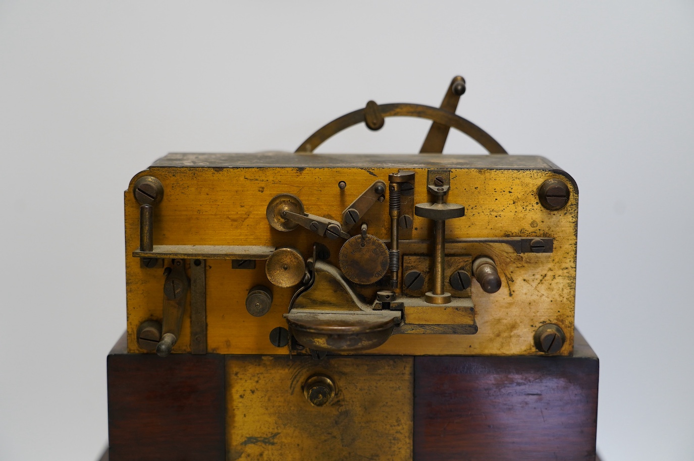 A late 19th century brass and mahogany Wheatstone type telegraph receiver (Morse inker), containing two drawers with paper rolls, 30cm high, 30cm wide, 28cm deep.